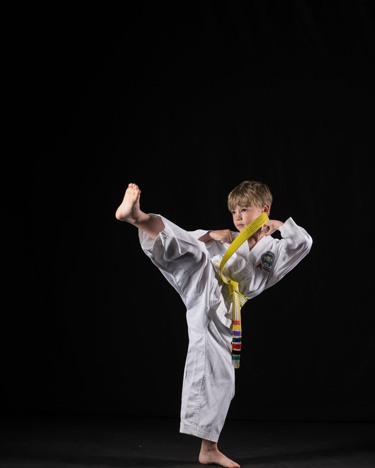 A young Apex student landing a high kick in class